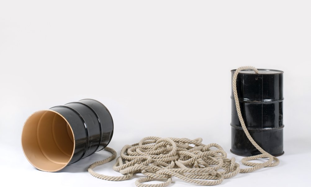 You can see two large oil barrels connected with a thick rope - like an oversized can telephone.