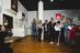 An interested group stands around the communicator in the museum and enjoys the tour.