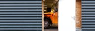 The bonnet of a historic post bus can be seen through the open door of the museum depot. - enlarged view