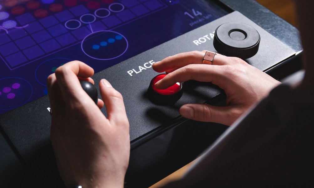 Close-up of hands of a student playing a computer game in the exhibition.