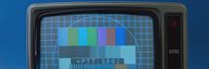 Im Bild ist ein Fernsehgerät der 1970er-Jahre zu sehen. Darauf das farbige Testbild von SRG und PTT. - vergrösserte Ansicht