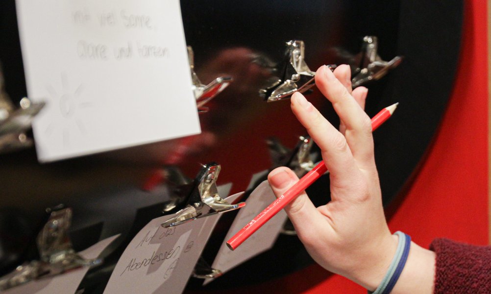 Close-up of a hand holding a pencil.